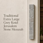 Handcrafted Jerusalem stone mezuzah case with carved Shin symbol, textured surface, and natural grey tones, mounted on a wall.