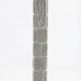 Handcrafted Jerusalem stone mezuzah with carved Shin symbol, textured surface, natural grey tones, and architectural presence for doorways.
