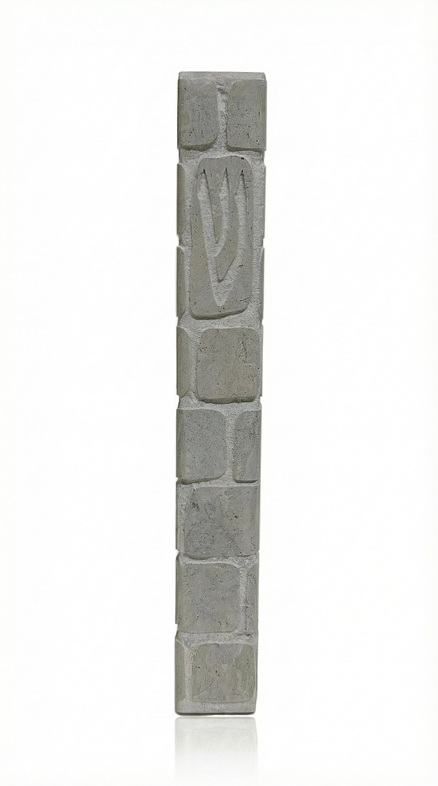 High-quality handcrafted Jerusalem stone mezuzah with carved Shin symbol, textured natural grey stone, in a white studio background with soft reflection.