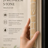 Close-up of the undecorated cream Jerusalem stone mezuzah showing natural fossil flecking.