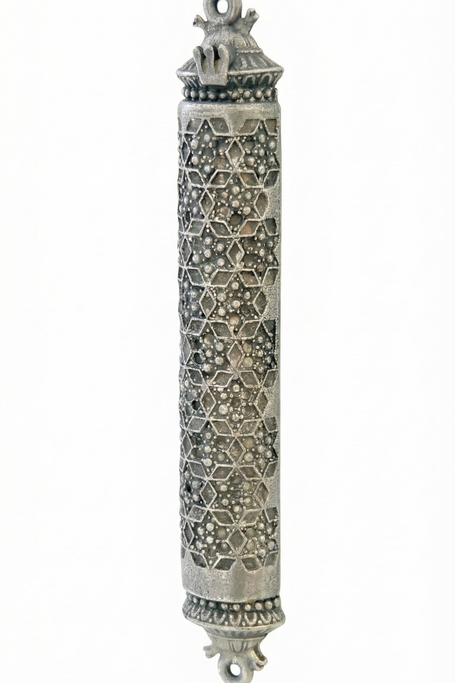 Ornate pewter mezuzah with detailed Magen David design and decorative textured surface, mounted on a neutral white background with subtle reflection.