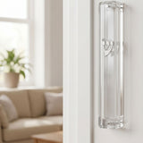 Modern clear Lucite mezuzah case with silver Shin, mounted inside a stylish doorway handle on a clean doorframe.
