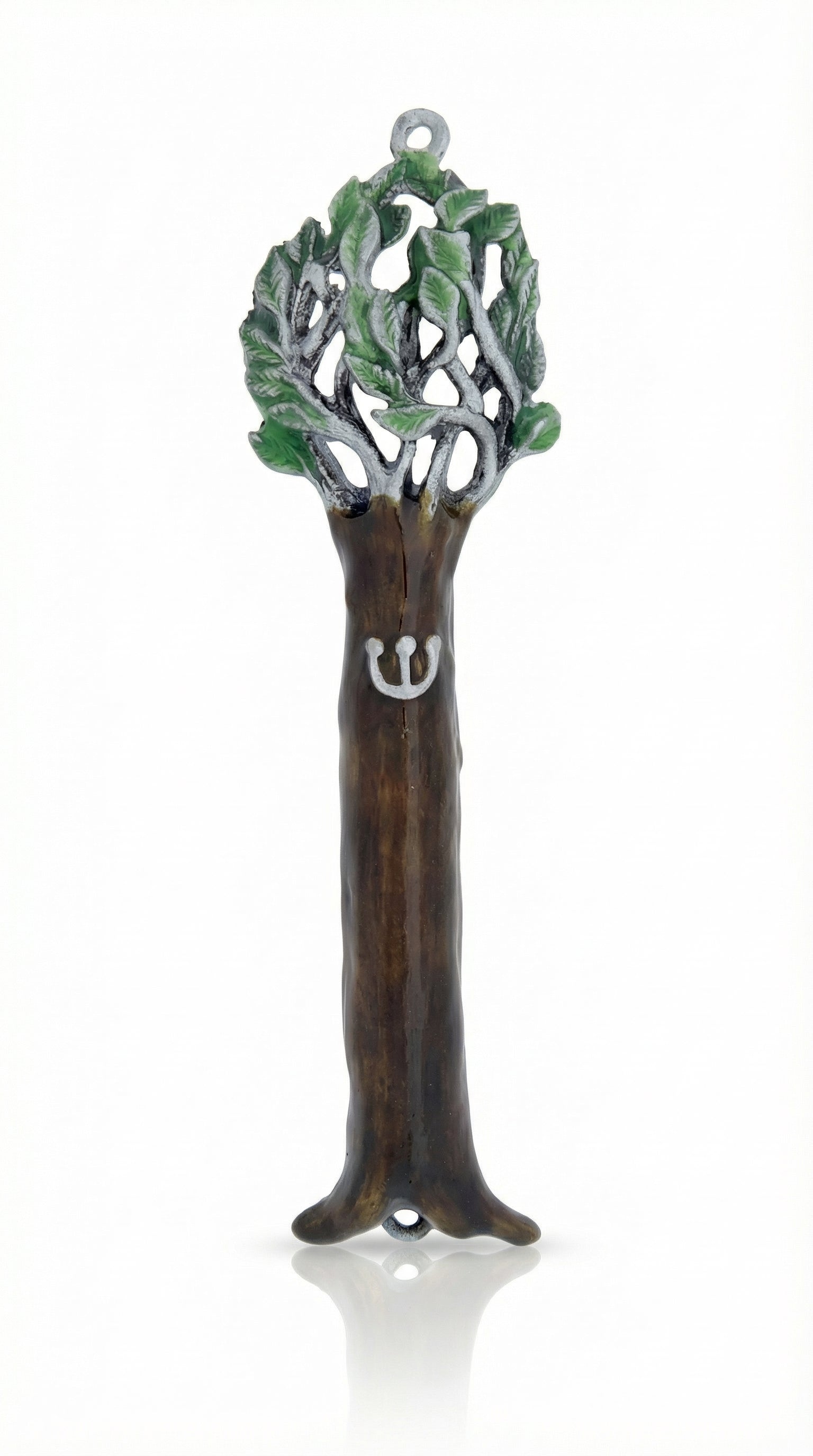Pewter Tree of Life Mezuzah reflecting symbolism of the Torah as a tree of life, detailed engraving, on a white studio surface with soft reflection.