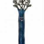 Pewter mezuzah with blue enamel depicting the tree of life, finely detailed and oriented vertically, on a white background with a subtle reflection.