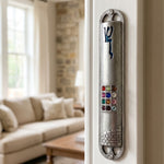 Decorative Twelve Stones Jerusalem Pewter Mezuzah mounted on interior doorway, showcasing multicolored stones and Jerusalem motif in a traditional Jewish setting.