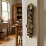 Lifestyle scene featuring the vintage coins of Israel brass mezuzah mounted on an interior doorway jamb showcasing traditional Judaica style.