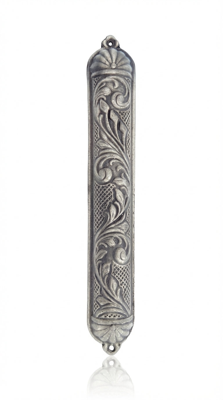 Detailed vintage Moroccan pewter mezuzah with Hebrew inscriptions, on a white studio background with a subtle reflection.
