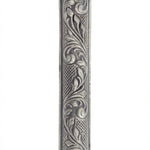 Detailed vintage Moroccan pewter mezuzah with Hebrew inscriptions, on a white studio background with a subtle reflection.
