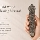 Hand holding vintage pewter mezuzah case with antique texture and symbolic medallions, showcasing old world charm and character.
