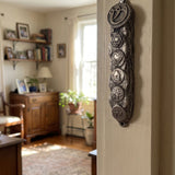 Vintage pewter mezuzah with aged silver finish and antique texture on a doorway inside a traditional home, showcasing classic Judaica style.