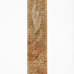 High-resolution image of a handmade Jerusalem stone mezuzah with engraved full Shema text, black-painted Hebrew letters, and frosted glass Shin, on a white studio background with soft reflection.