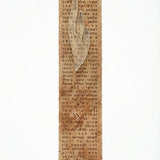 High-resolution image of a handmade Jerusalem stone mezuzah with engraved full Shema text, black-painted Hebrew letters, and frosted glass Shin, on a white studio background with soft reflection.