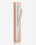 Modern Capital Shin pink aluminum mezuzah case on white with a soft pink body and a large angular silver Hebrew Shin
