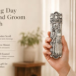 Wedding Day Bride and Groom mezuzah case held beside a doorway, featuring an ornate silver-tone pewter design with a sculpted Jewish bride and groom beneath a decorative wedding canopy. Made in Israel, this wedding mezuzah case fits a 4-inch kosher scroll and makes a meaningful Jewish wedding or new home gift