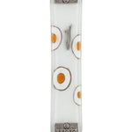 White fused-glass Mezuzah with hand-painted white and silver circles, textured silver metal accents at top and bottom, on a polished white surface.