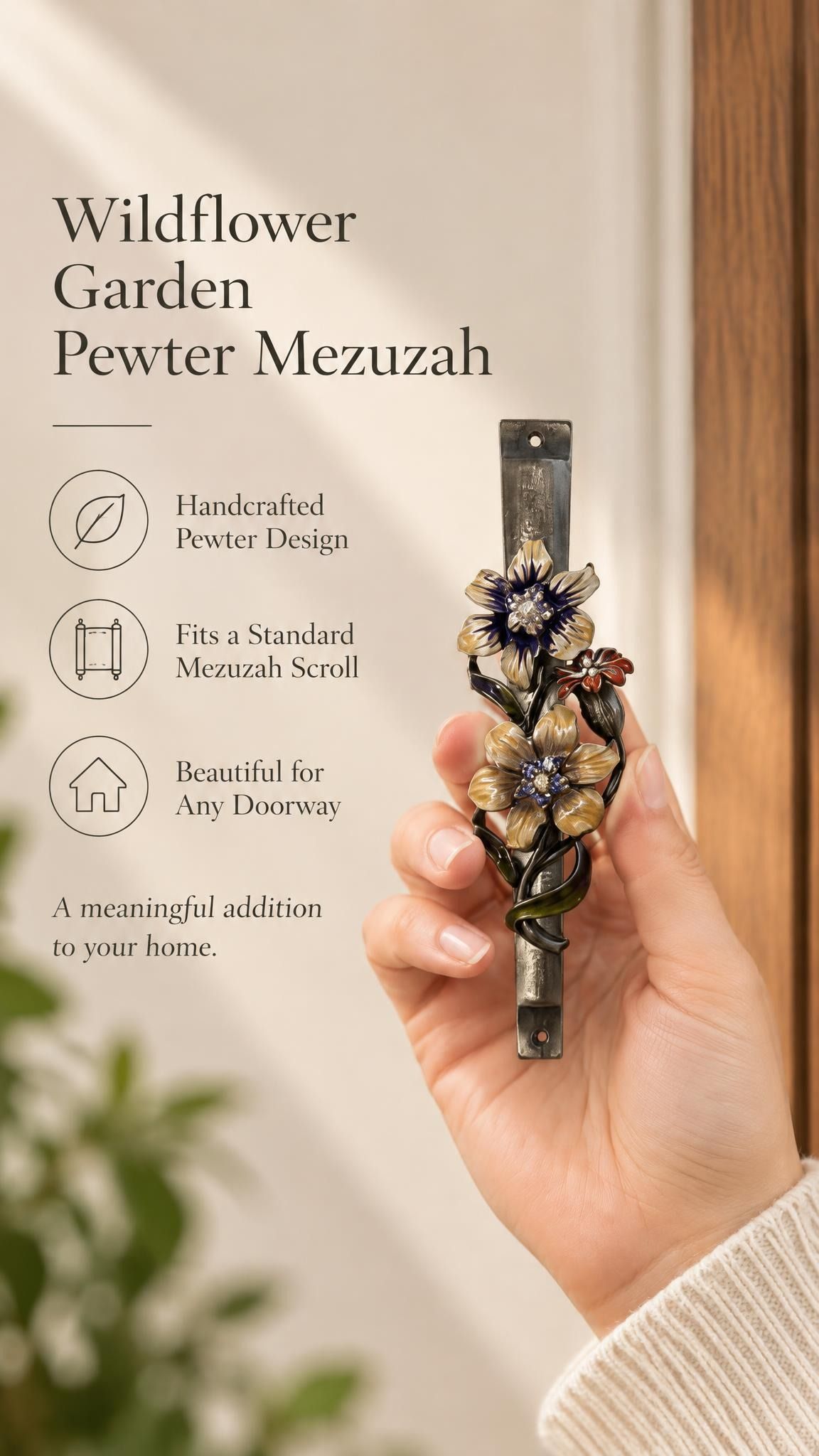 Handheld portrait of the Wildflower Garden Pewter Mezuzah mezuzah cover, with yellow and purple flowers with sparkling centers, green curling leaves and a small reddish blossom along a textured silver-toned pewter stem clearly visible beside the product name and illustrated features of this distinctive Jewish doorway design