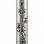 Wildflowers mezuzah with sky blue accents, detailed floral carvings, and Hebrew inscriptions, displayed on a white studio background with soft reflection.